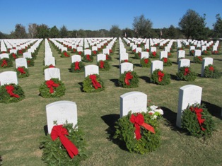 Hundres of green and red wreaths laid at veteran gravestones